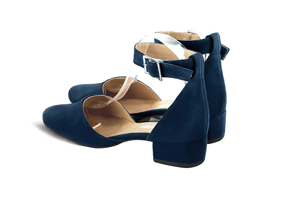 Women's navy blue open side dress shoes, with a strap around the ankle. Round toe. Low block heels - Rear view